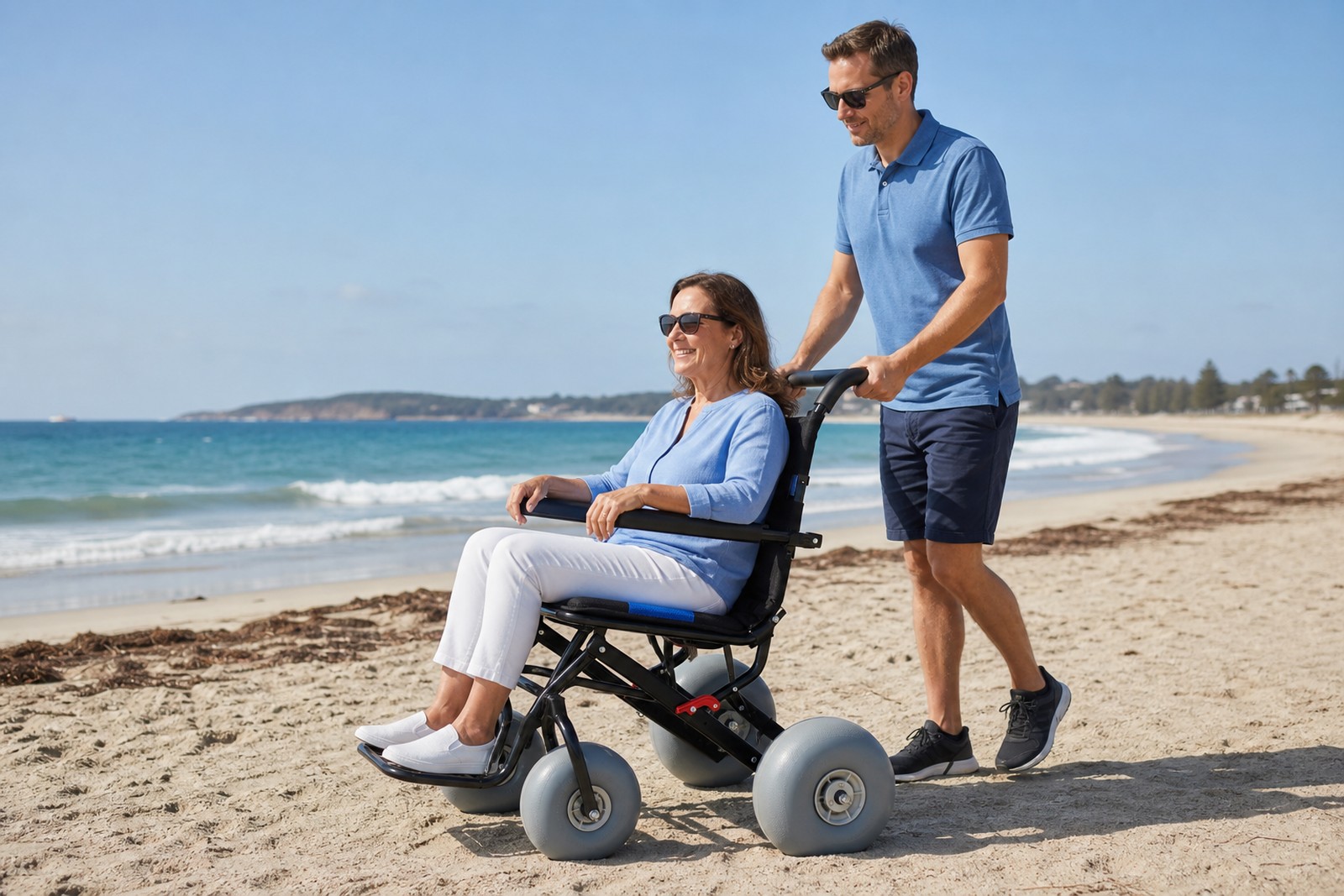 Lightweight beach wheelchair traveling over soft sand